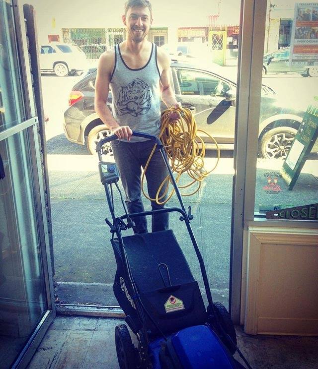 TTL member returning lawnmower through doorway